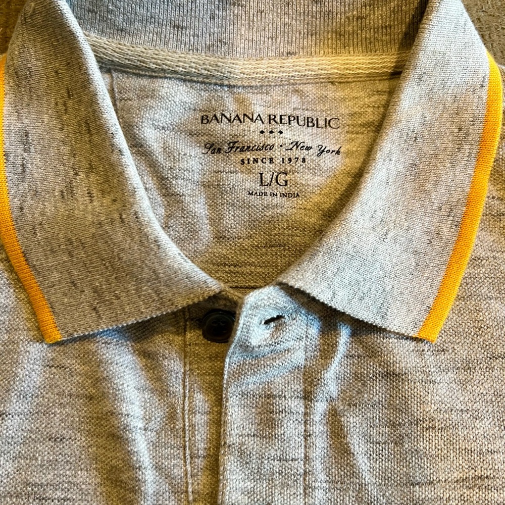 Heathered gray polo with orange contrast on sleeves and collar